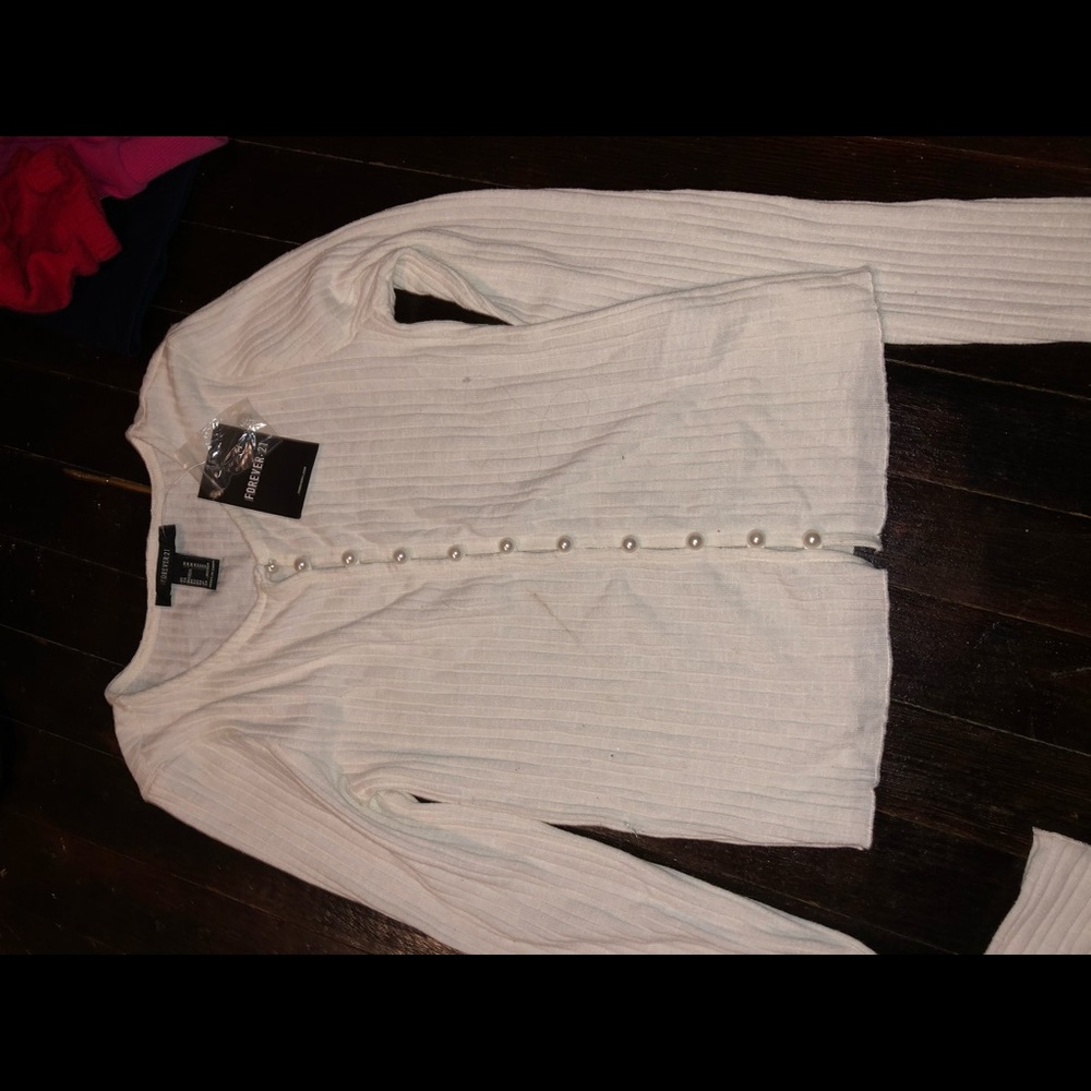A black & a white shirt with pearls